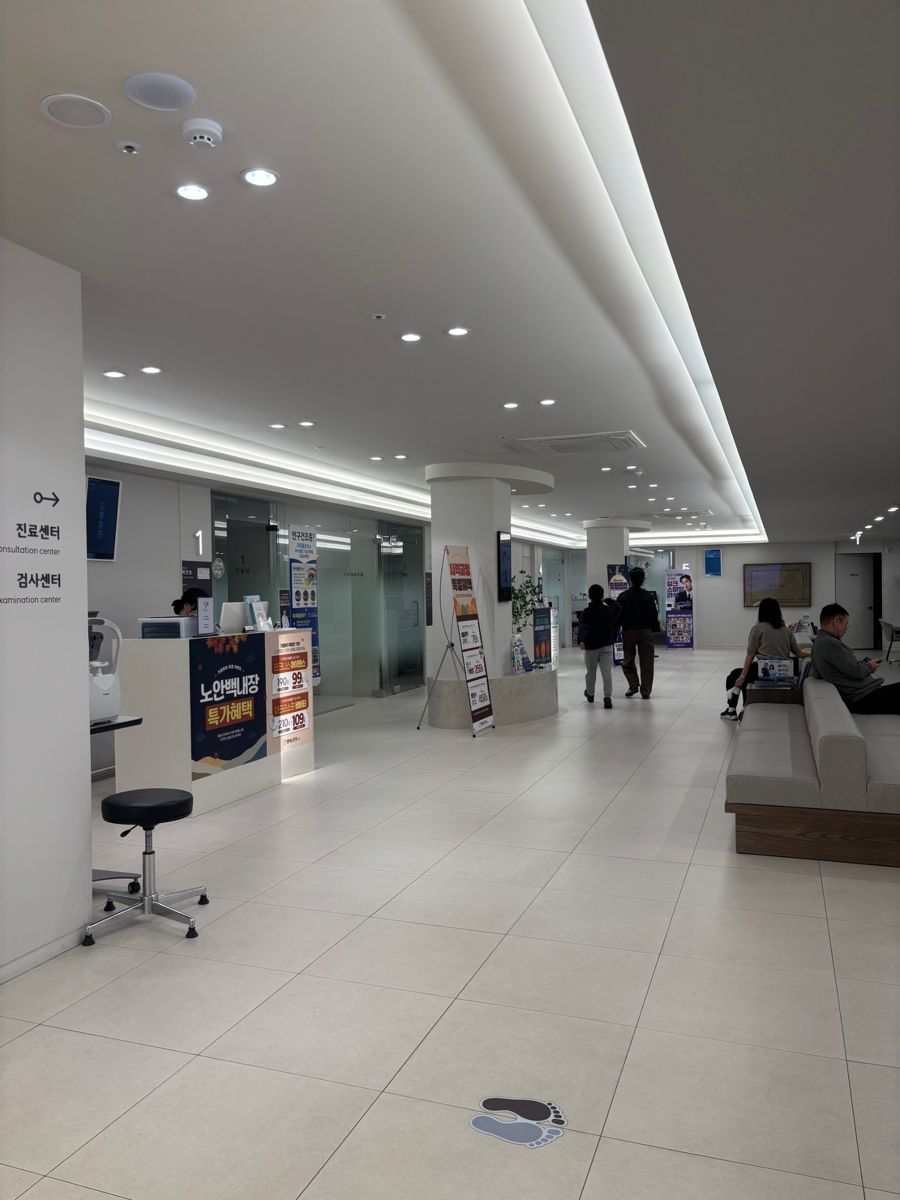 Bright eye-clinic lobby with a reception desk and waiting area