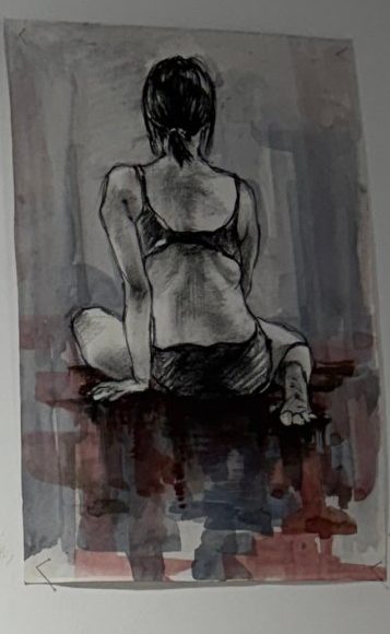 Seated figure from behind in charcoal over a red and grey wash