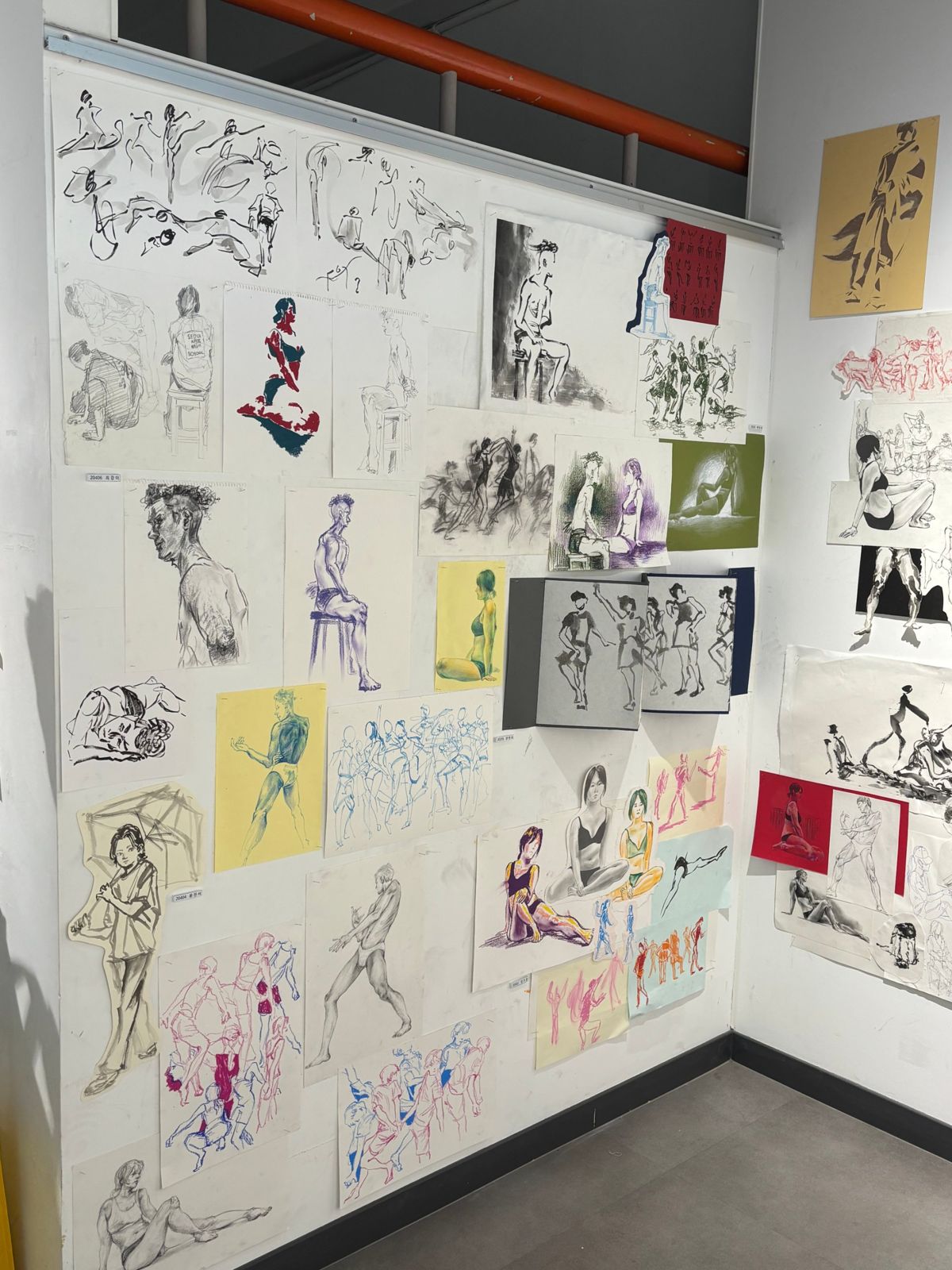 Close view of figure drawings on a white wall